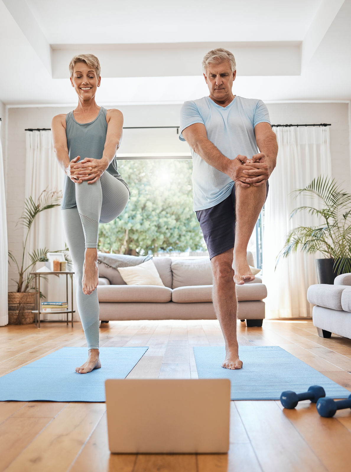 mature-couple-laptop-and-home-yoga-tutorial-in-ho-2022-12-10-02-20-47-utc.jpg